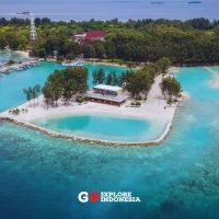 Pemandangan Pulau Payung Besar di Kepulauan Seribu dengan pantai alami, pepohonan hijau, dan laut jernih yang mengelilingi pulau.